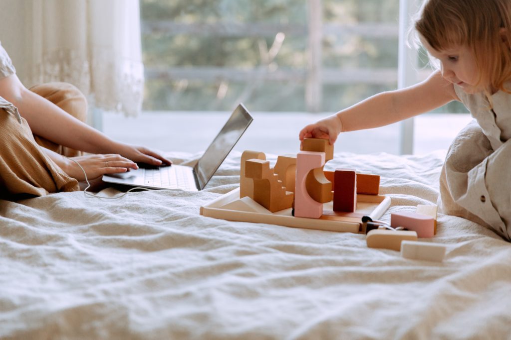 work-at-home mom with toddler buiding with blocks