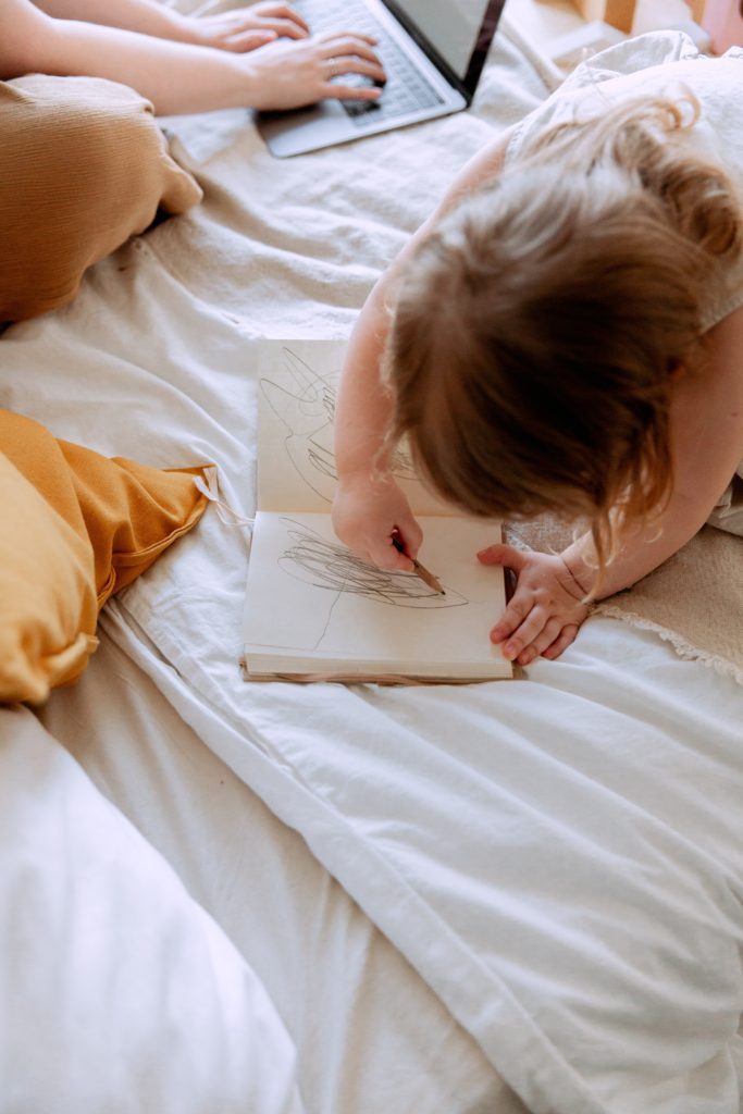 work at home mom with toddler drawing